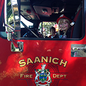 Child waving from fire truck
